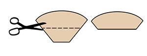 Scissors cutting coffee filter into two pieces