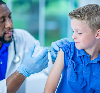 Healthcare provider giving shot to boy